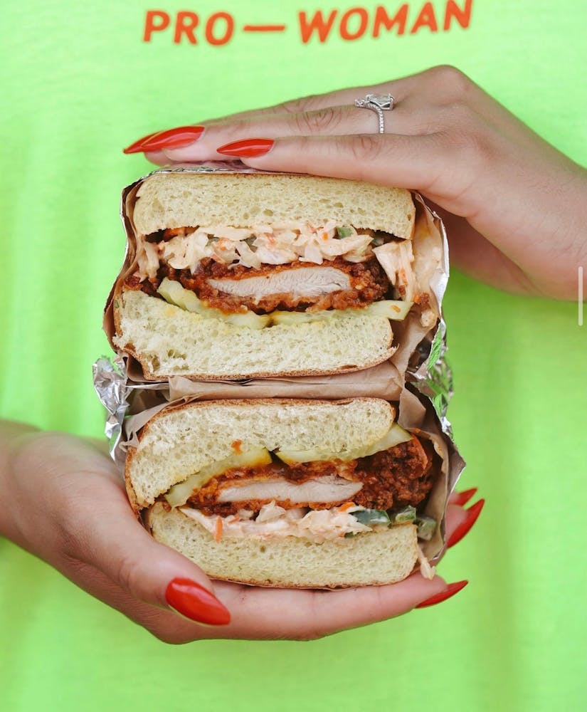 a hand holding a sandwich
