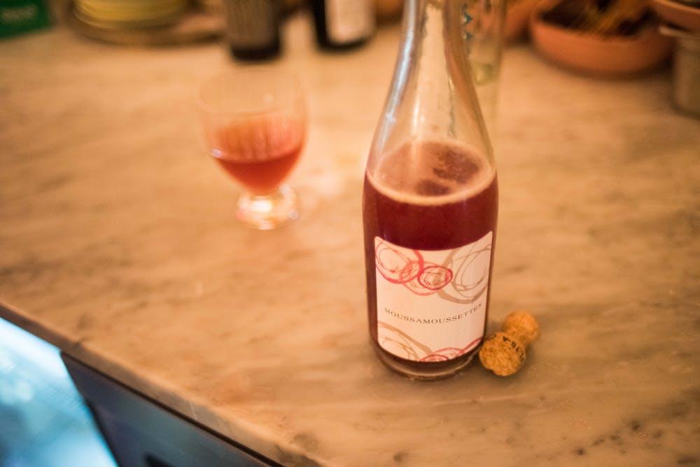 a close up of a bottle and a glass of wine