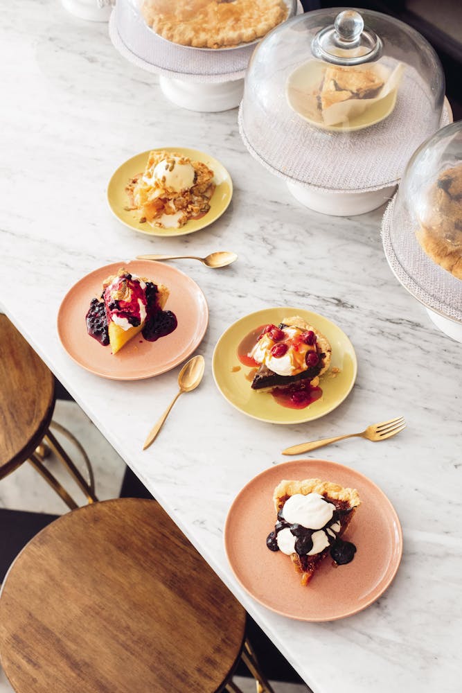 plates of pies sitting on top of a marble counter