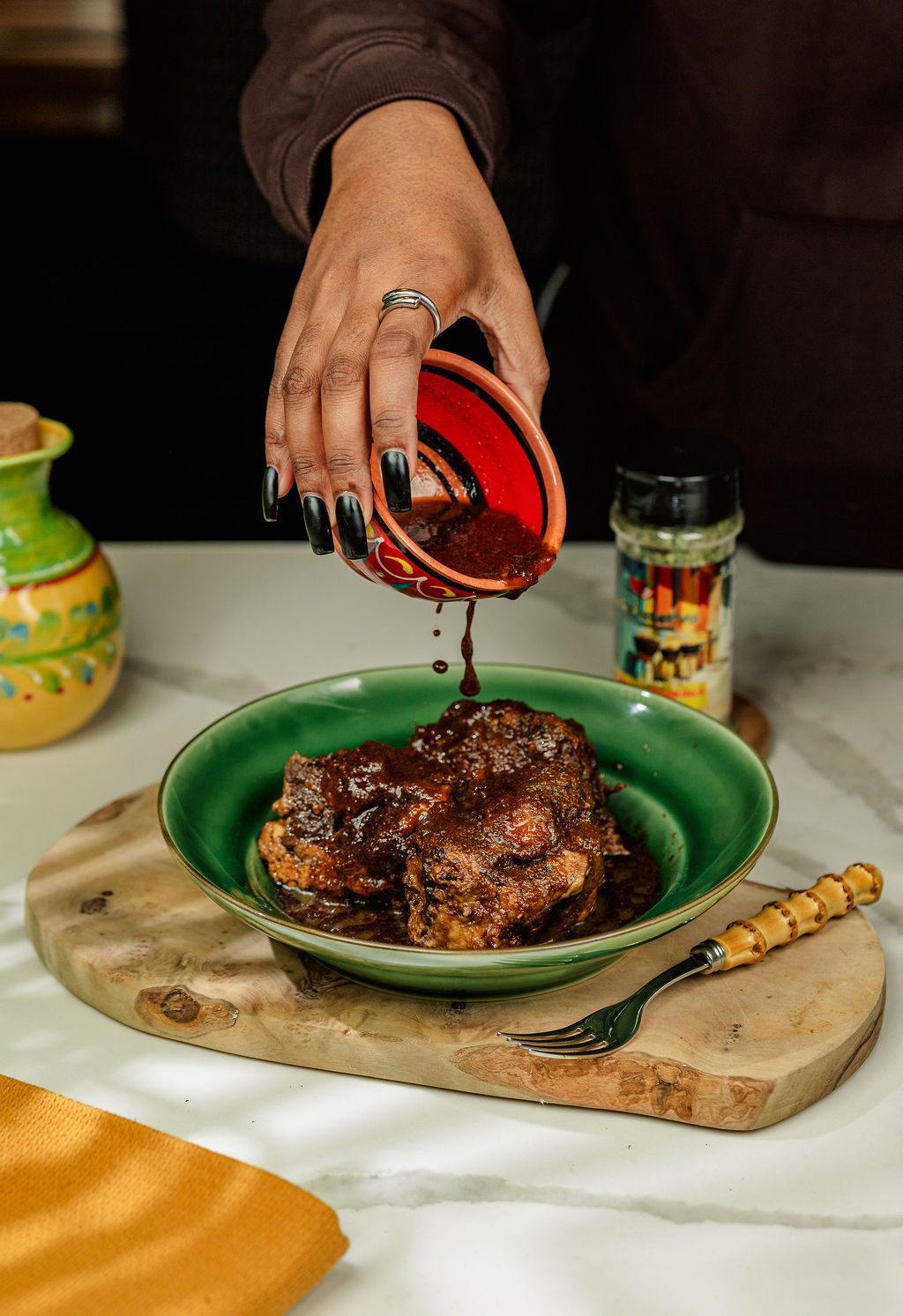 a person sitting at a table with a plate of food