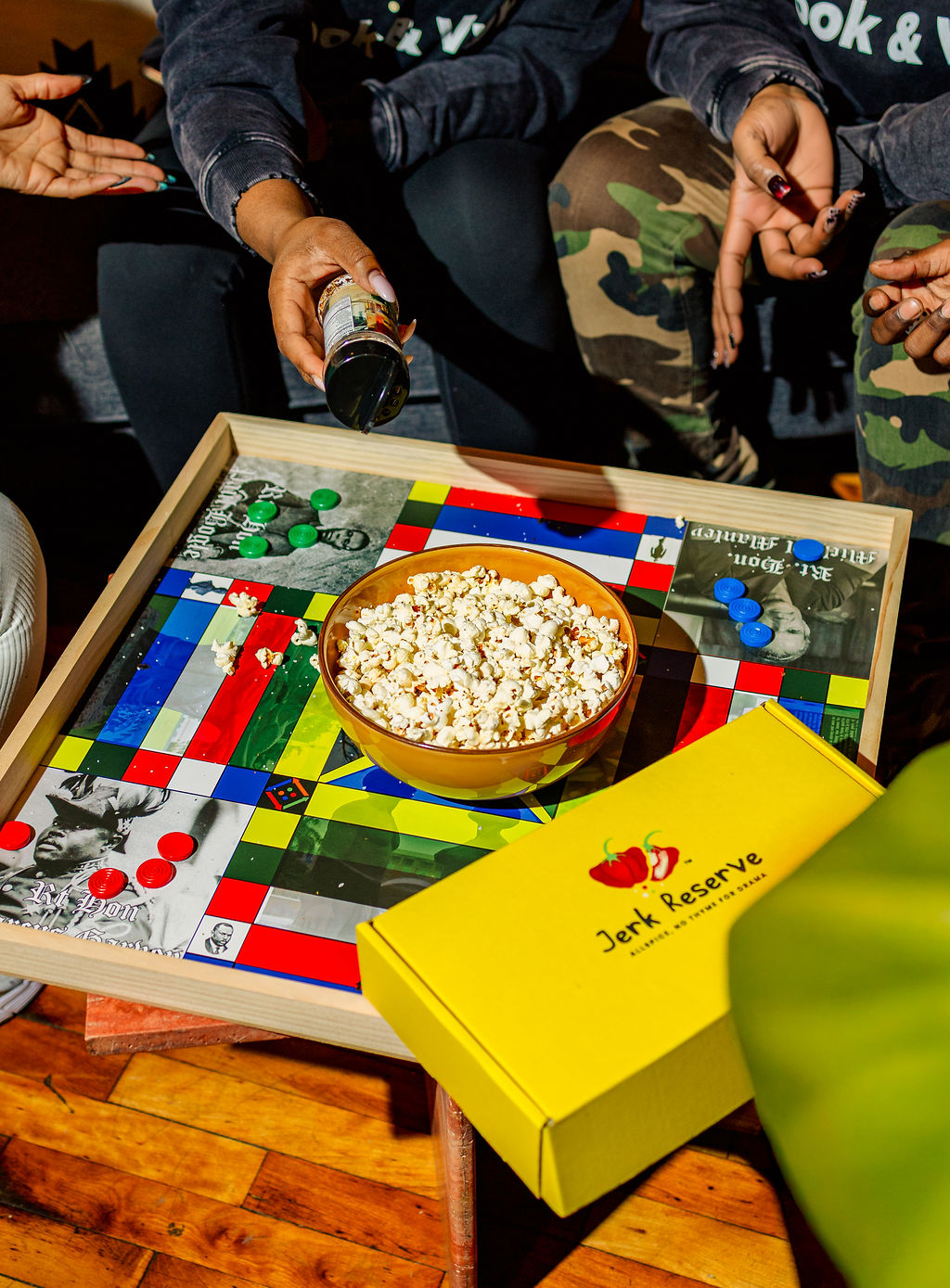 a group of people sitting at a table with a birthday cake