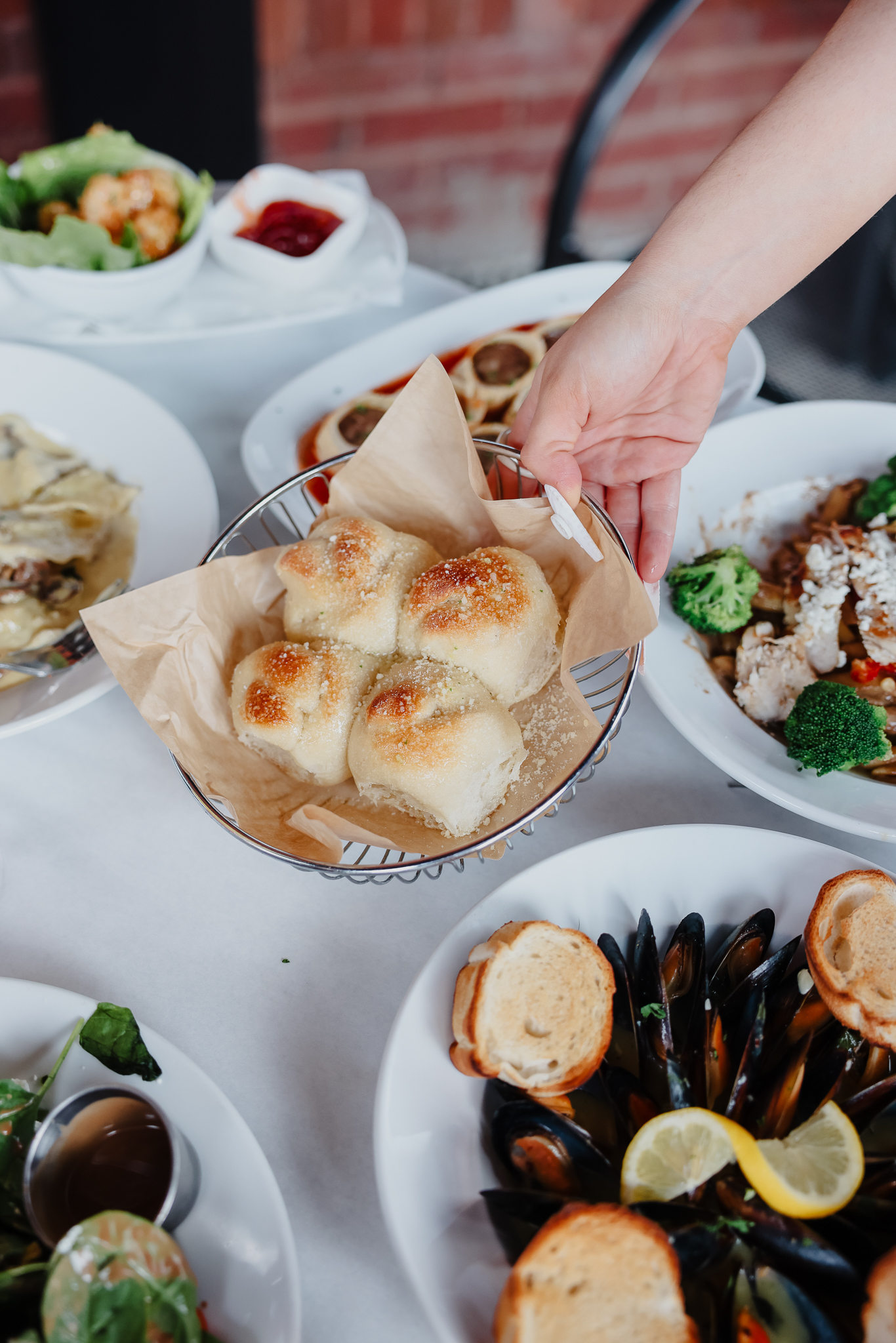 a group of people sitting at a table with a plate of food