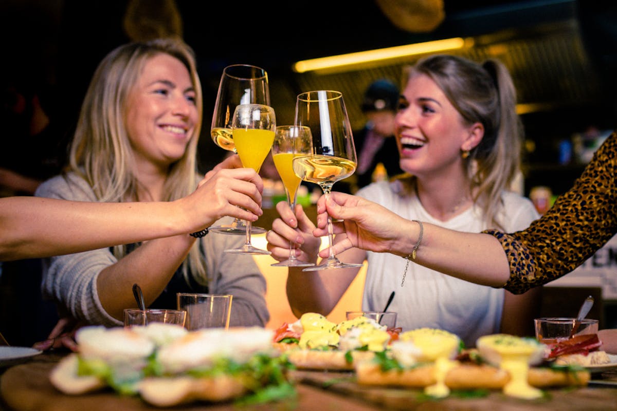 two women having brunch and having drinks