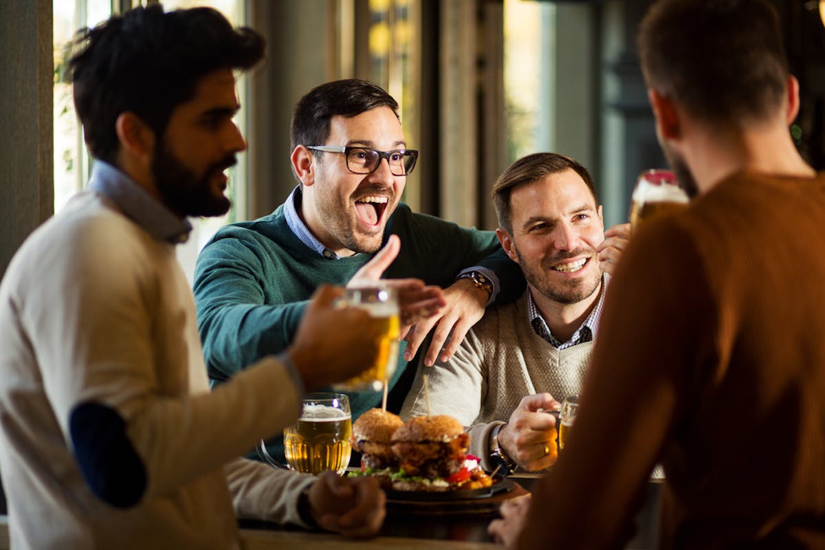 people enjoying food and drinks at night