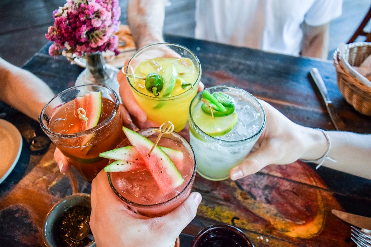 group cheers with cocktails
