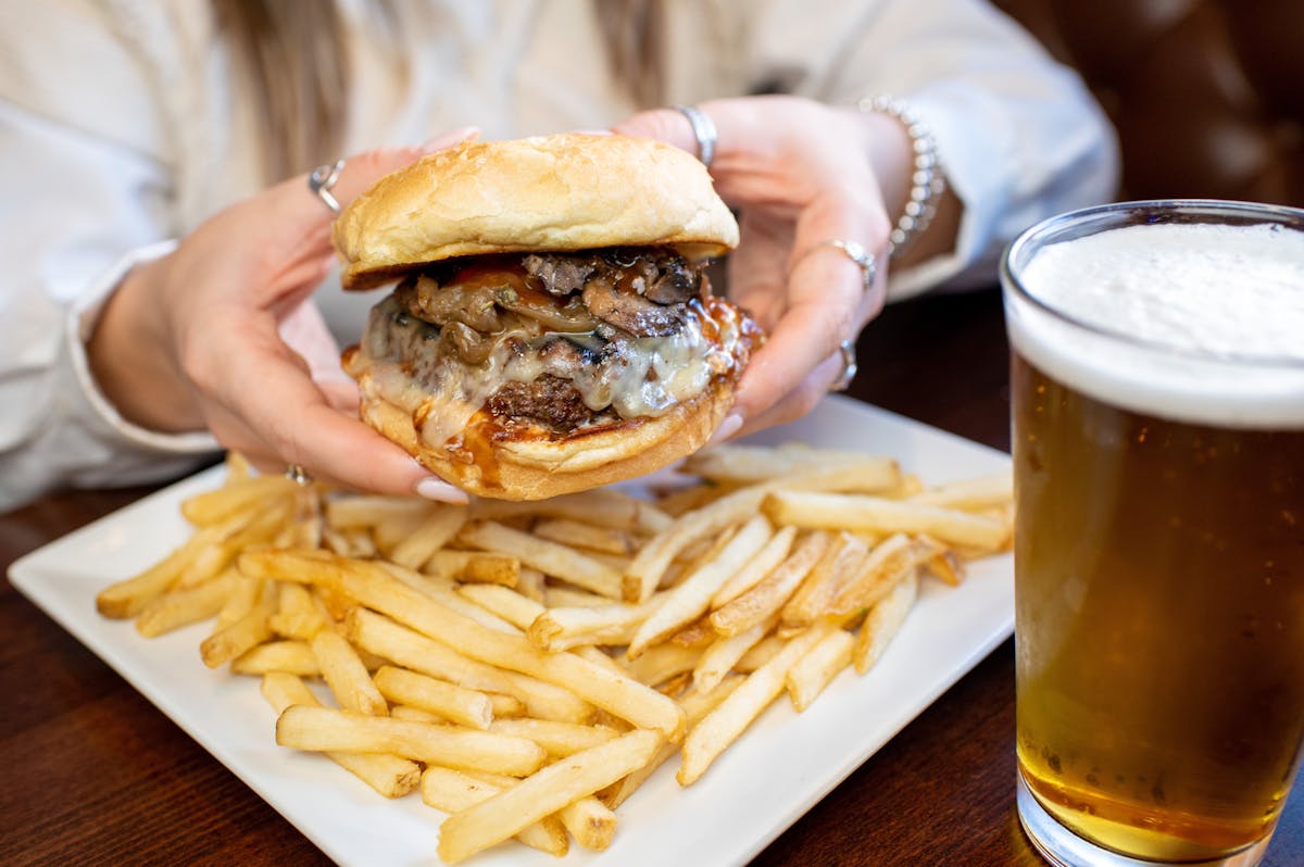 a close up of a sandwich and fries on a plate