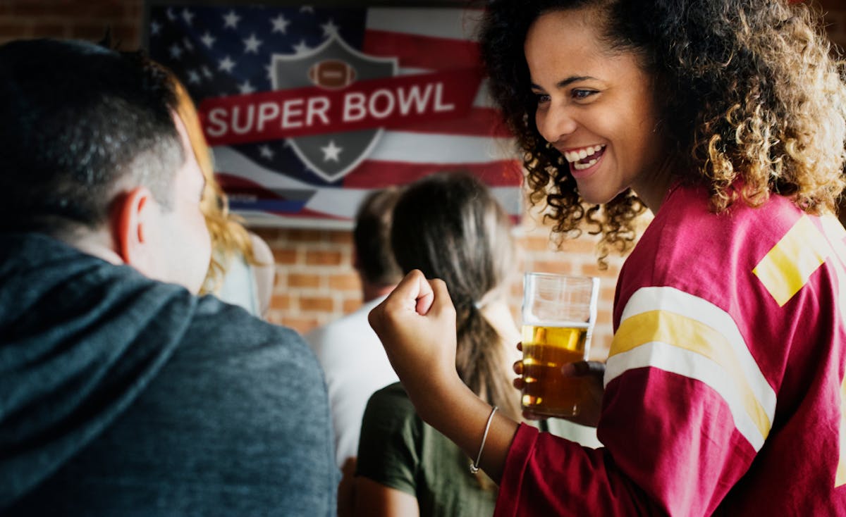 woman holding a beer during the Super Bowl
