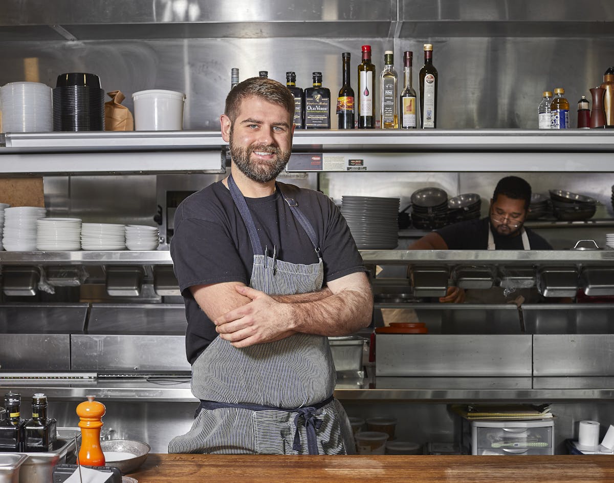 a man standing in a kitchen preparing food
