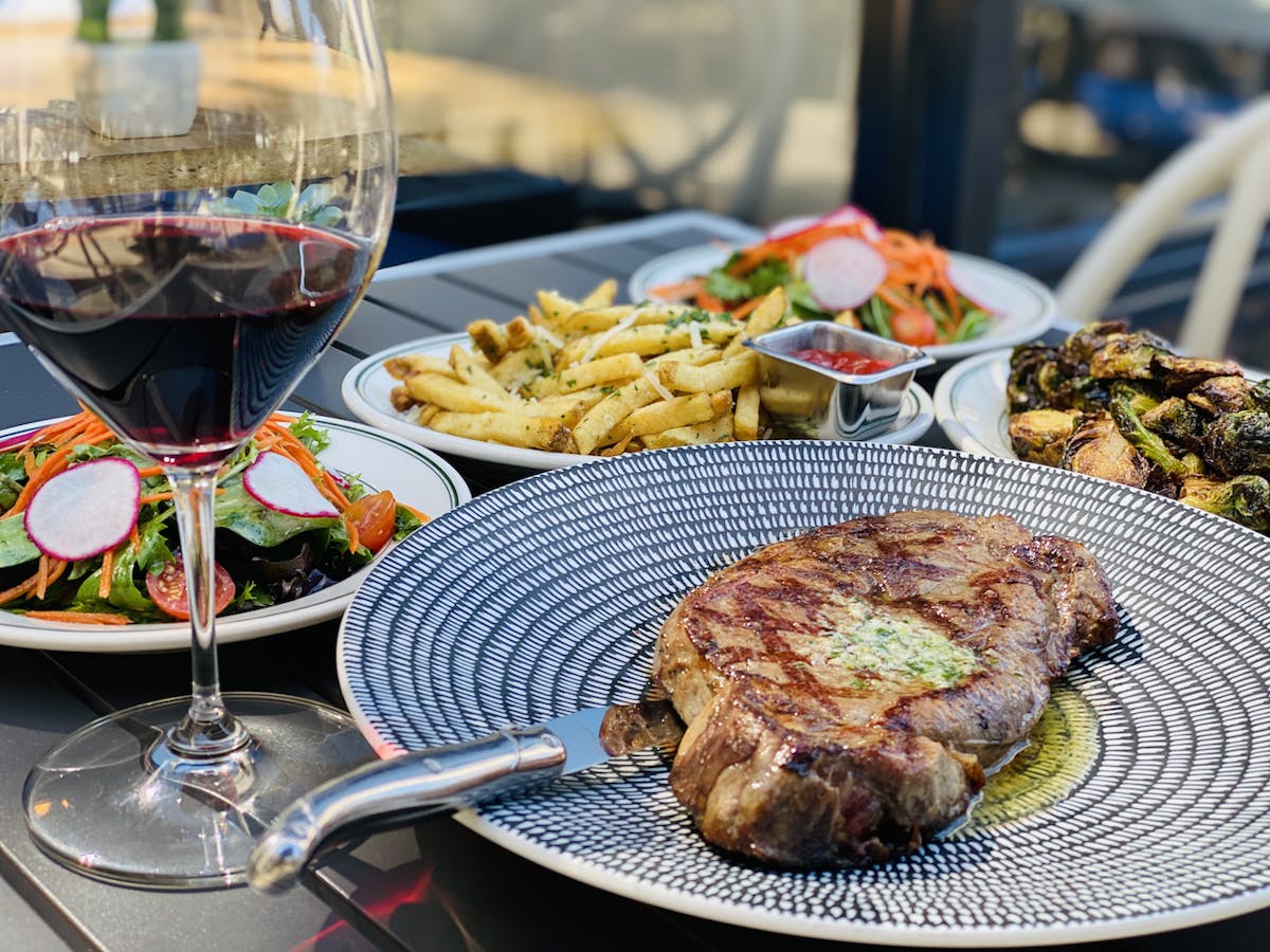 a plate of food and a glass of wine