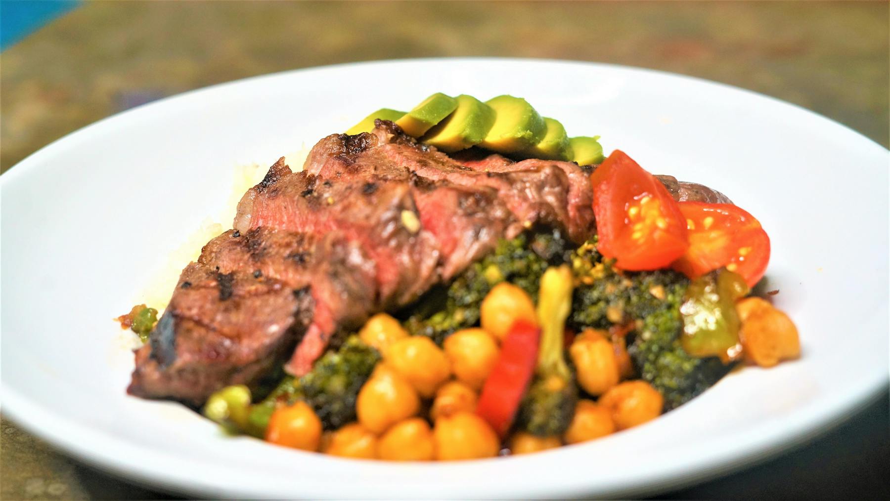 a white plate topped with meat and vegetables