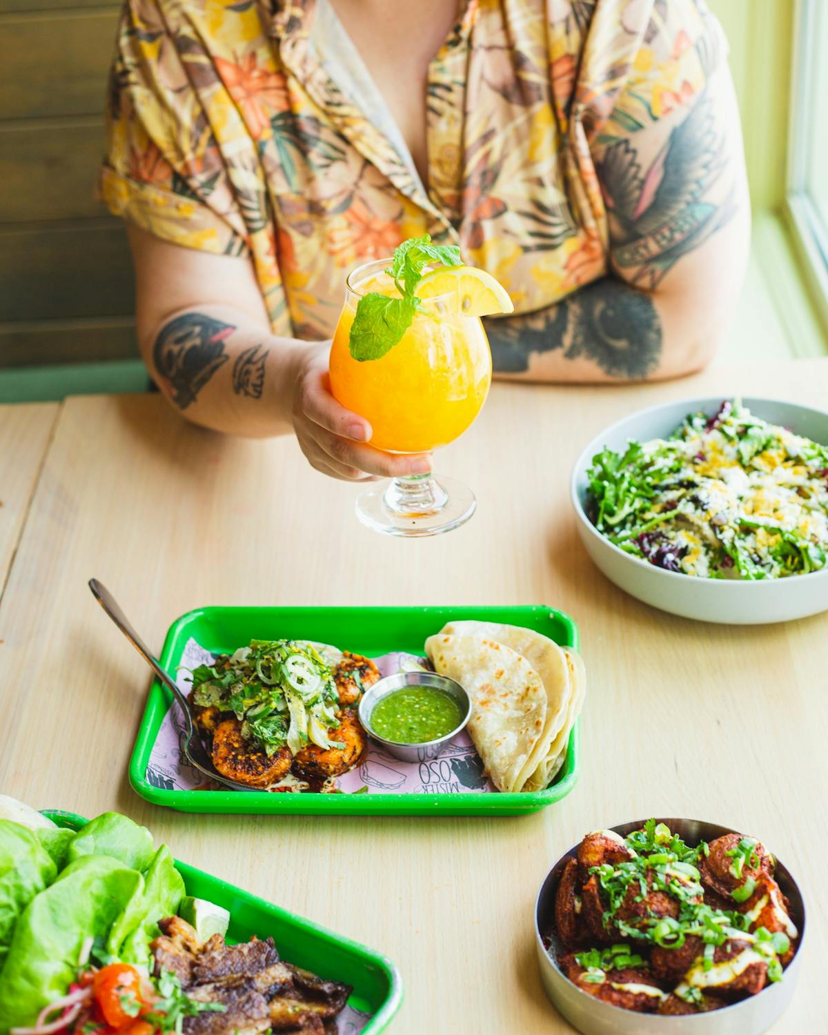 a person sitting at a table with a plate of food