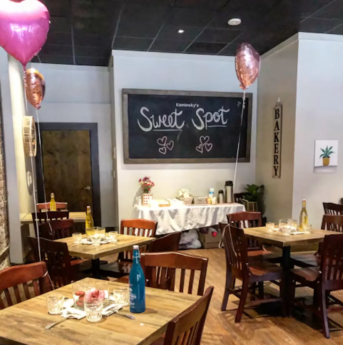 a room with tables and balloons