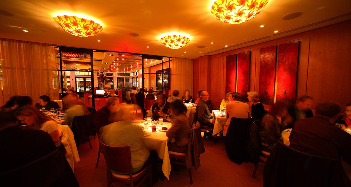 a group of people sitting at a table in a restaurant