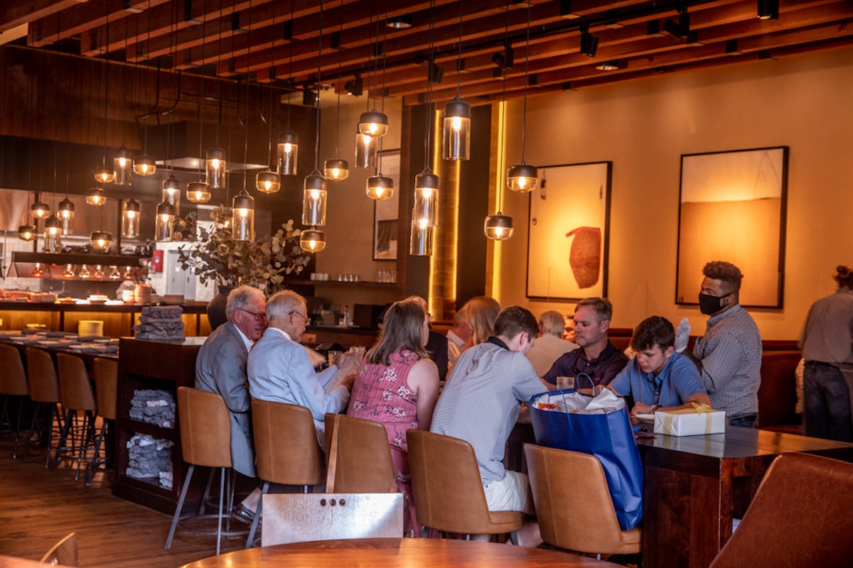 a group of people sitting at a table in a restaurant