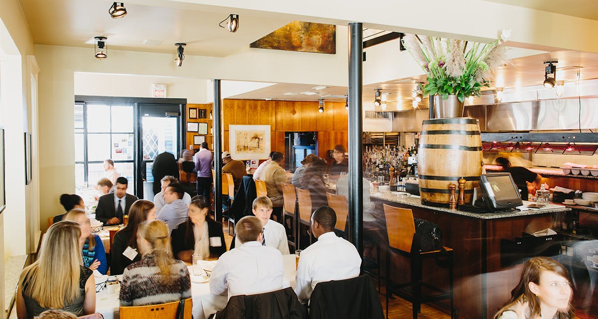 a group of people sitting at a table in a restaurant