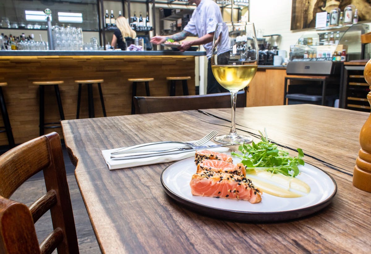 a plate of food sitting on top of a wooden table