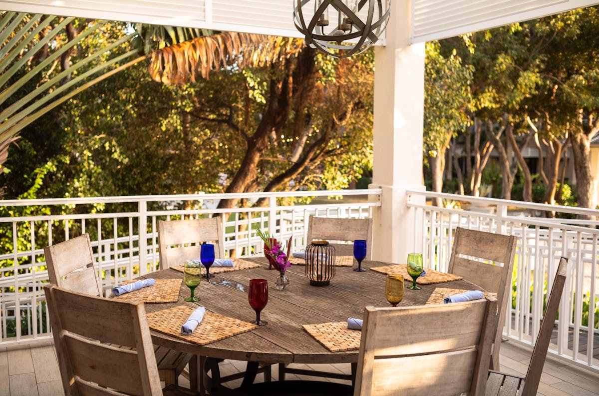 a dining room table in front of a fence