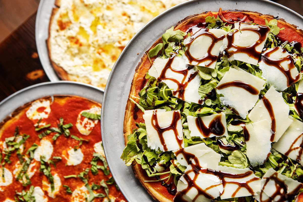 a pizza sitting on top of a plate of food