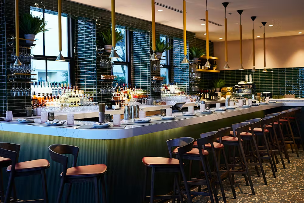 a bar with many chairs and a counter