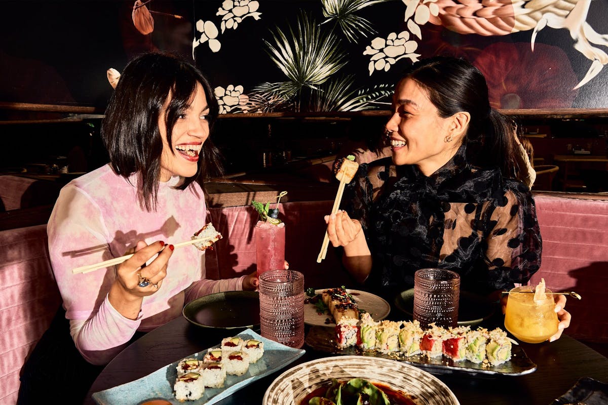 a man and a woman sitting at a table eating food