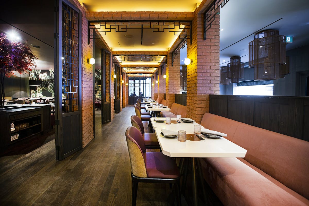 a room filled with furniture and a table in front of a building