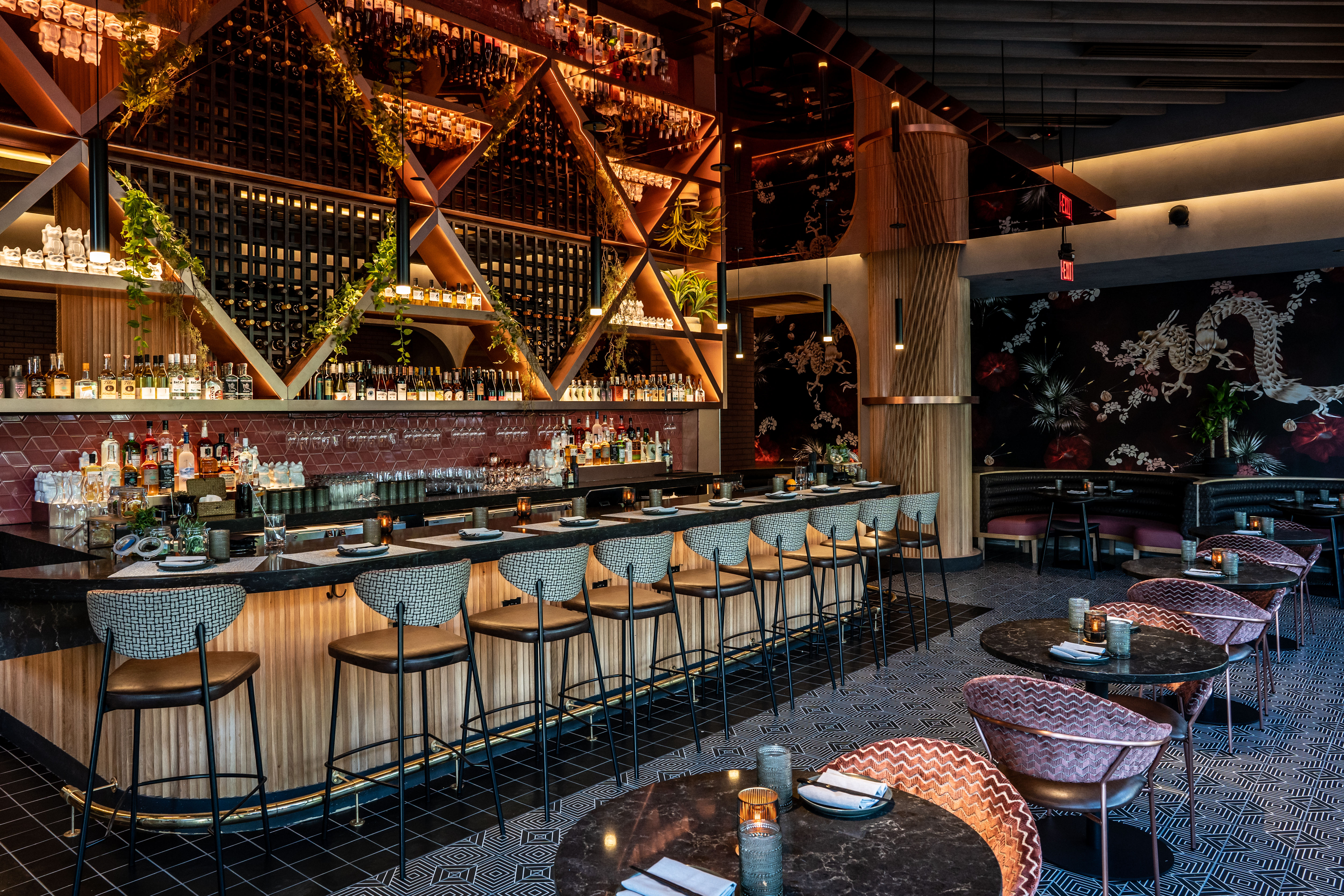 a bar with many chairs and tables