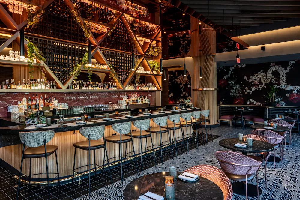 a bar with many chairs and tables