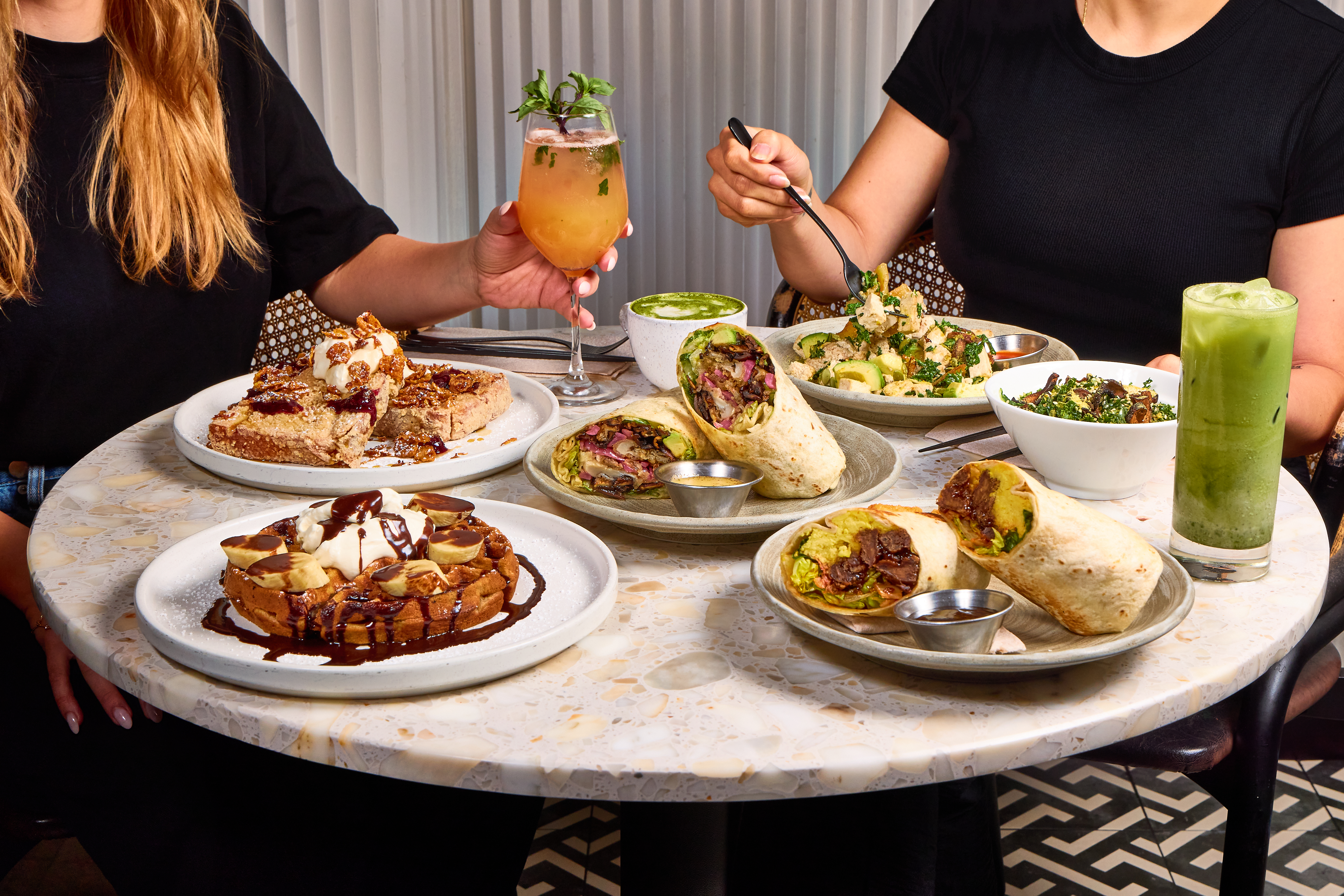 a table with plates of food and drinks