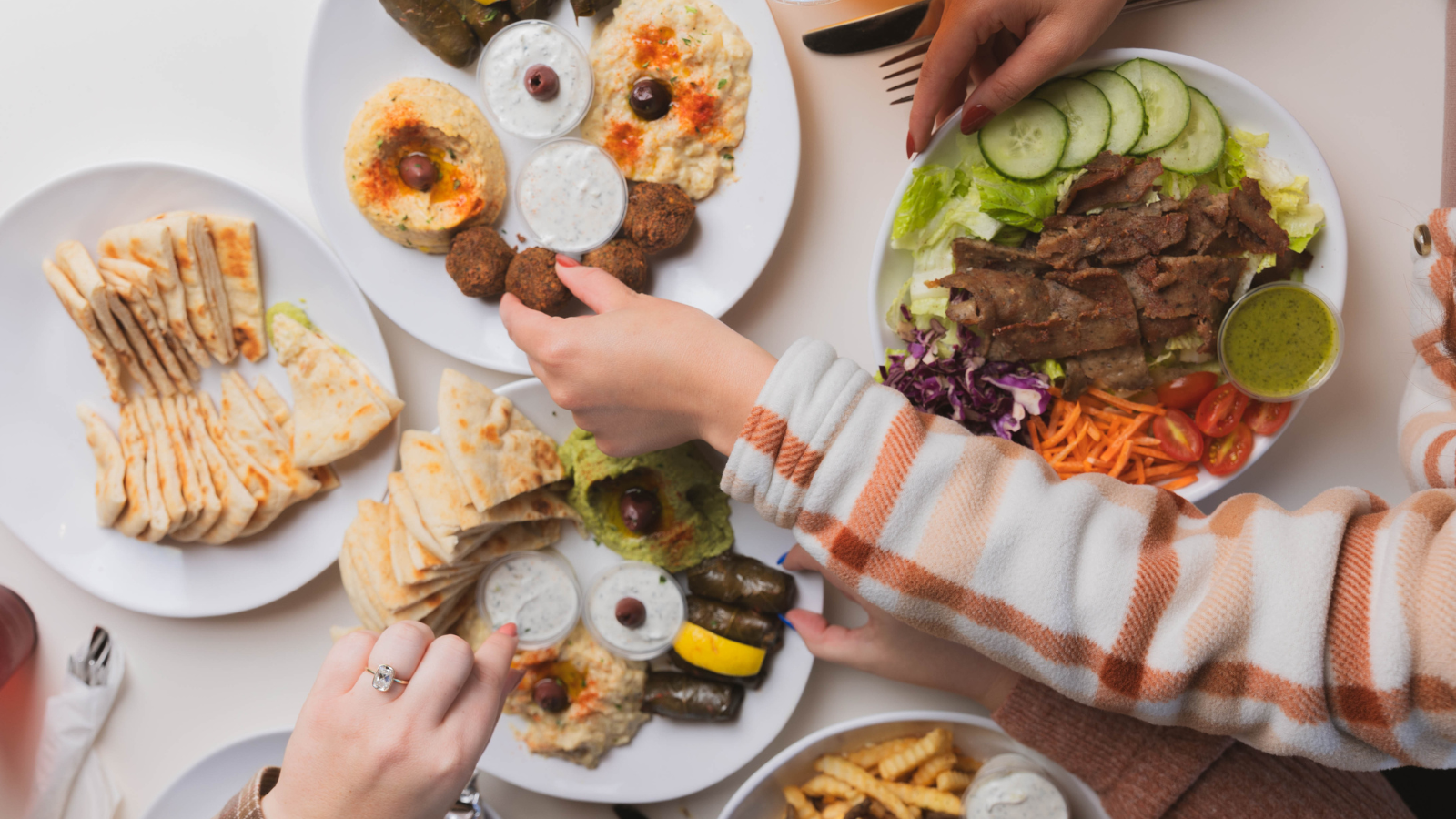 People sahring food across a large table