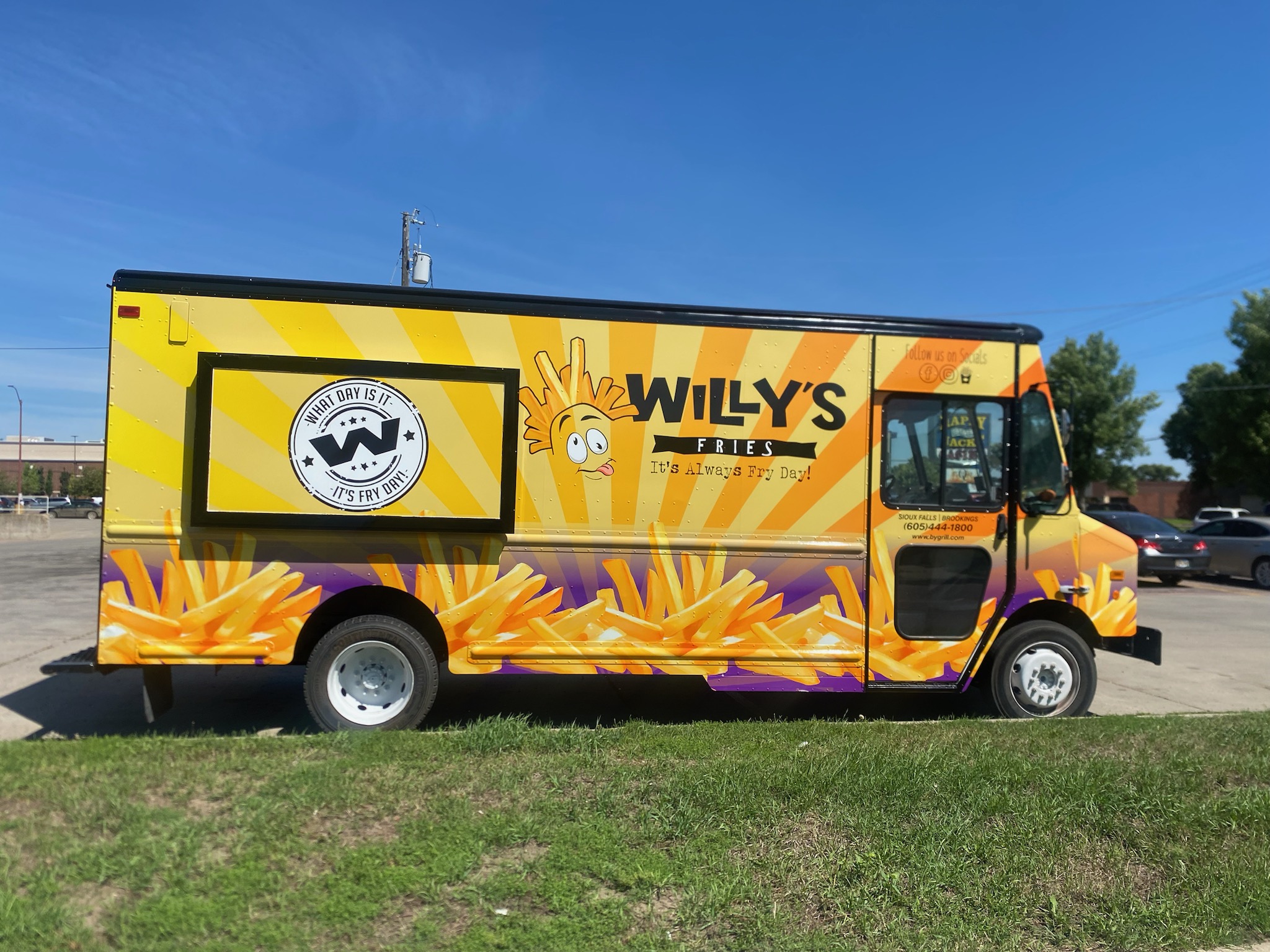 a large orange truck in a field