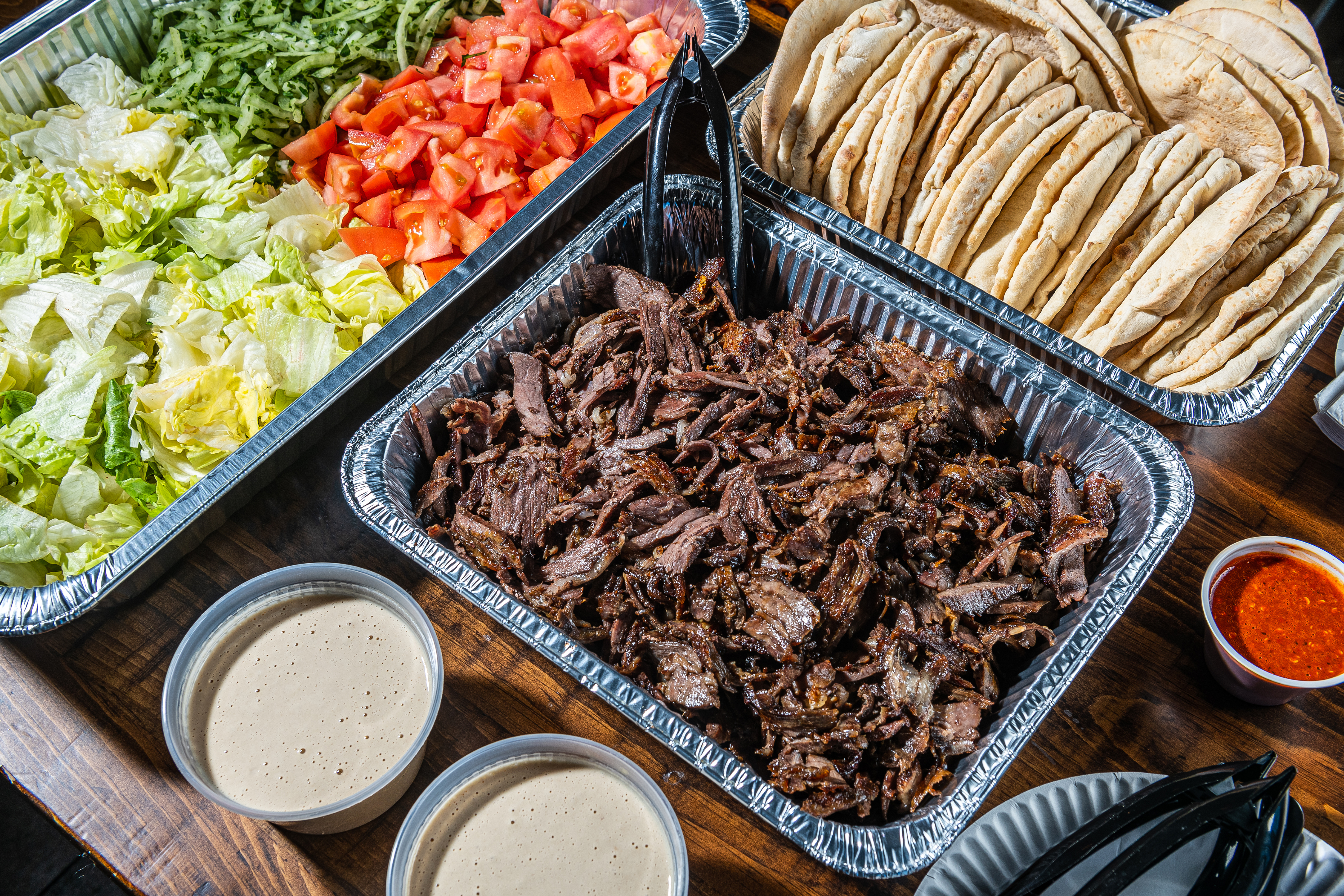Meat Party Platter with Pita Bread and Hot Sauce Catering Lifestyle Photo