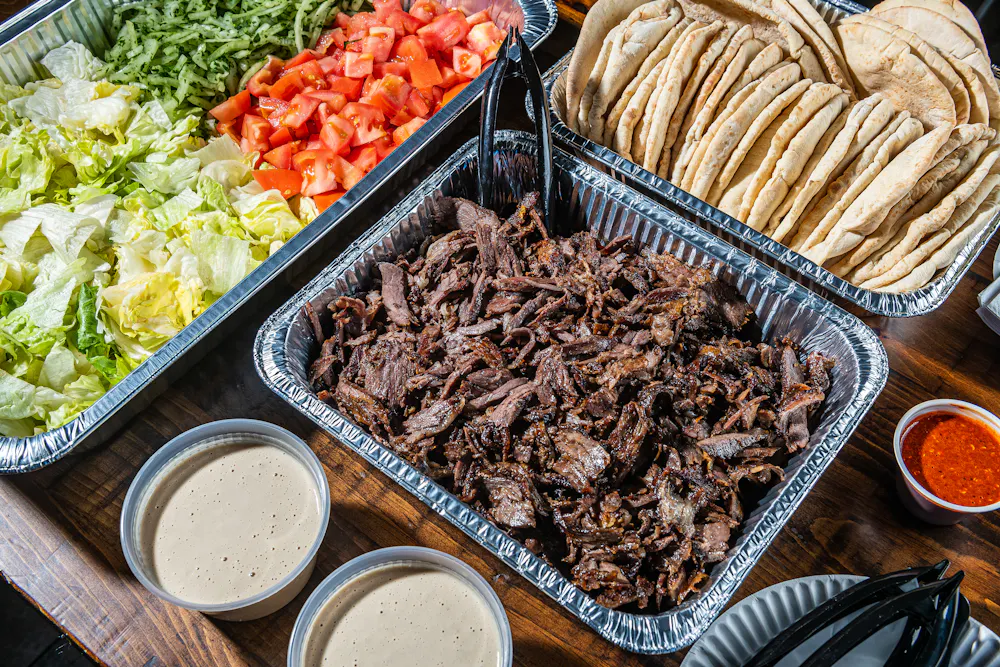Meat Party Platter with Pita Bread and Hot Sauce Catering Lifestyle Photo