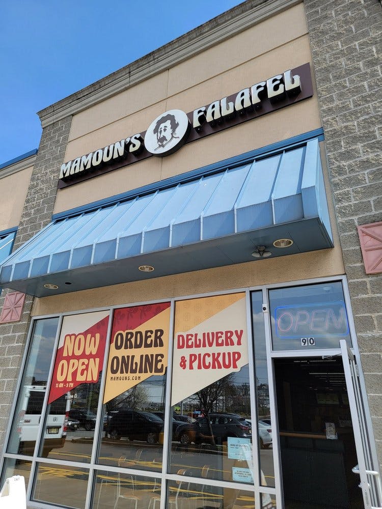 a sign above a store in a brick building