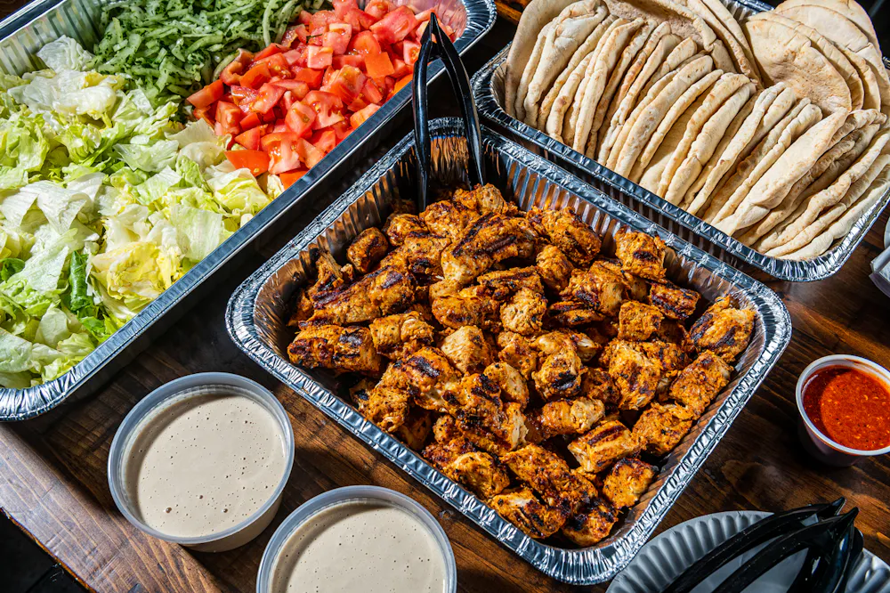 Chicken Kebob Sandwich Station with Pita Bread and Tahineh Sauce Catering Lifestyle Photo