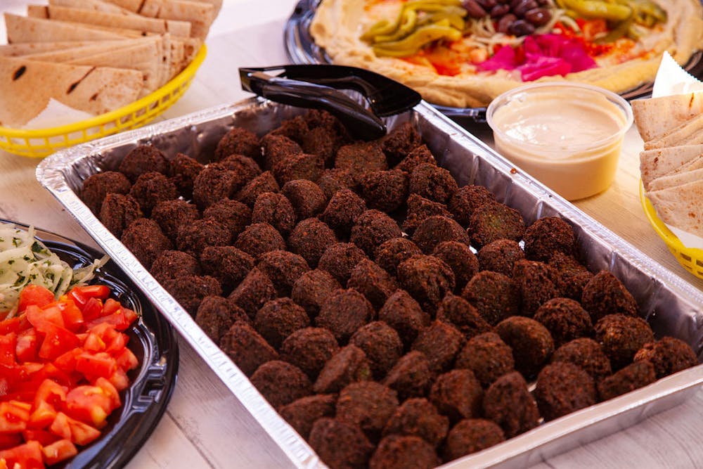 Falafel Tray, Hummus Tray, Tahineh Sauce, and Pita Bread Catering Lifestyle Photo