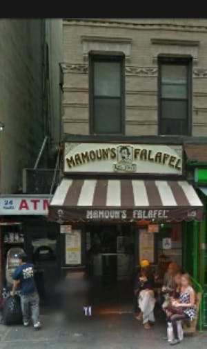 a group of people walking in front of a store