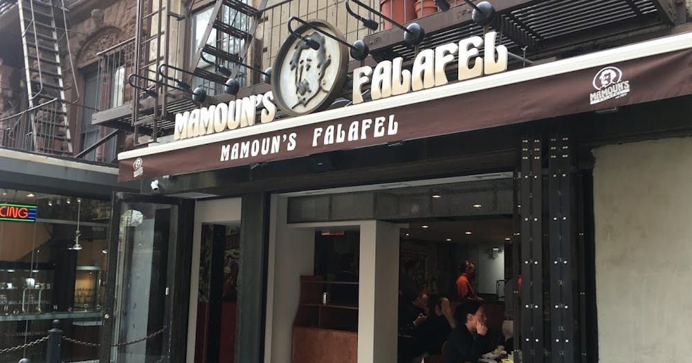 a group of people standing in front of a store