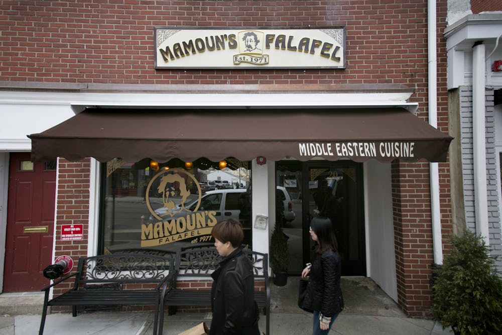 a person standing in front of a store in a brick building