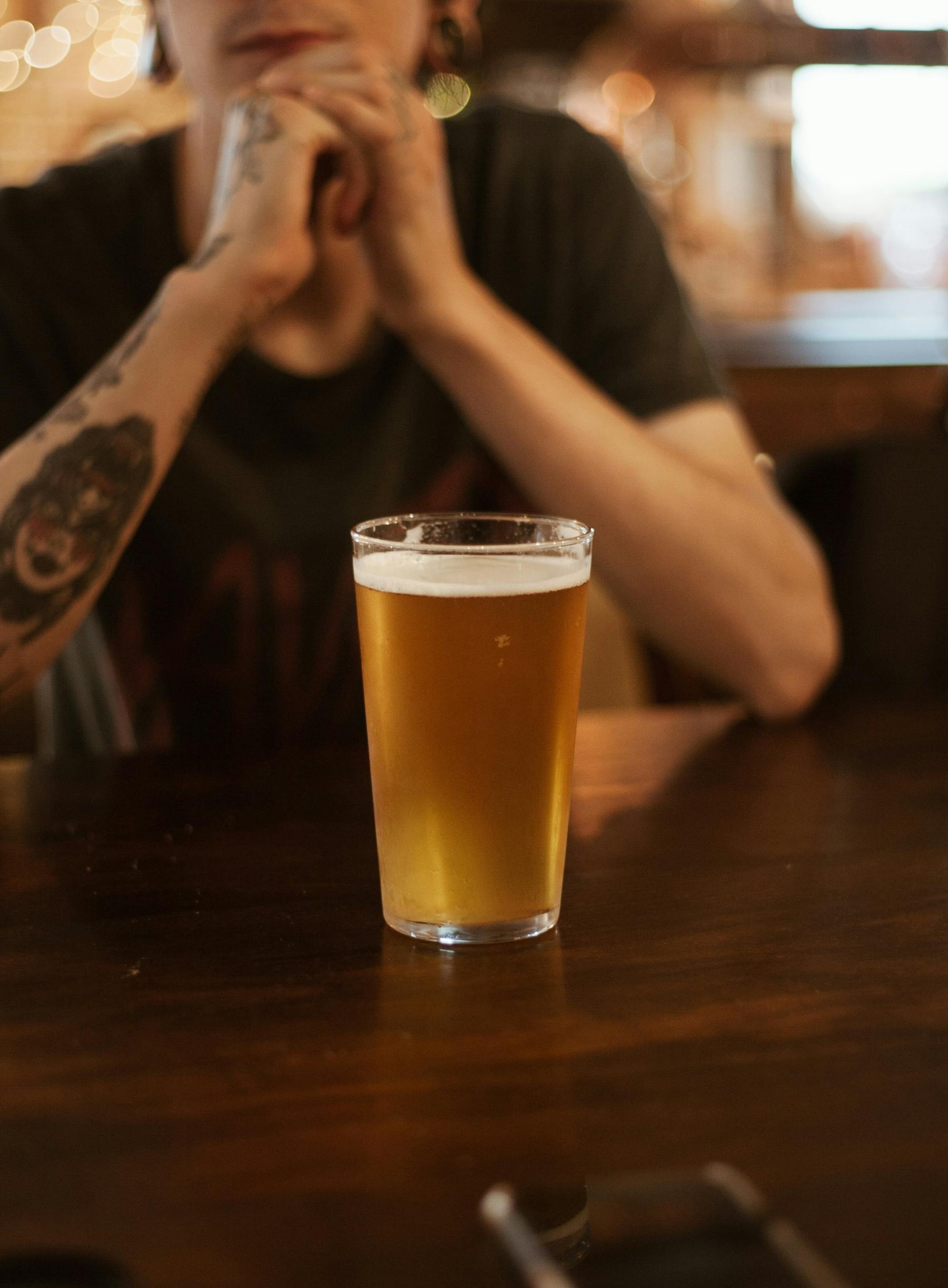 a person sitting at a table with a cup of coffee