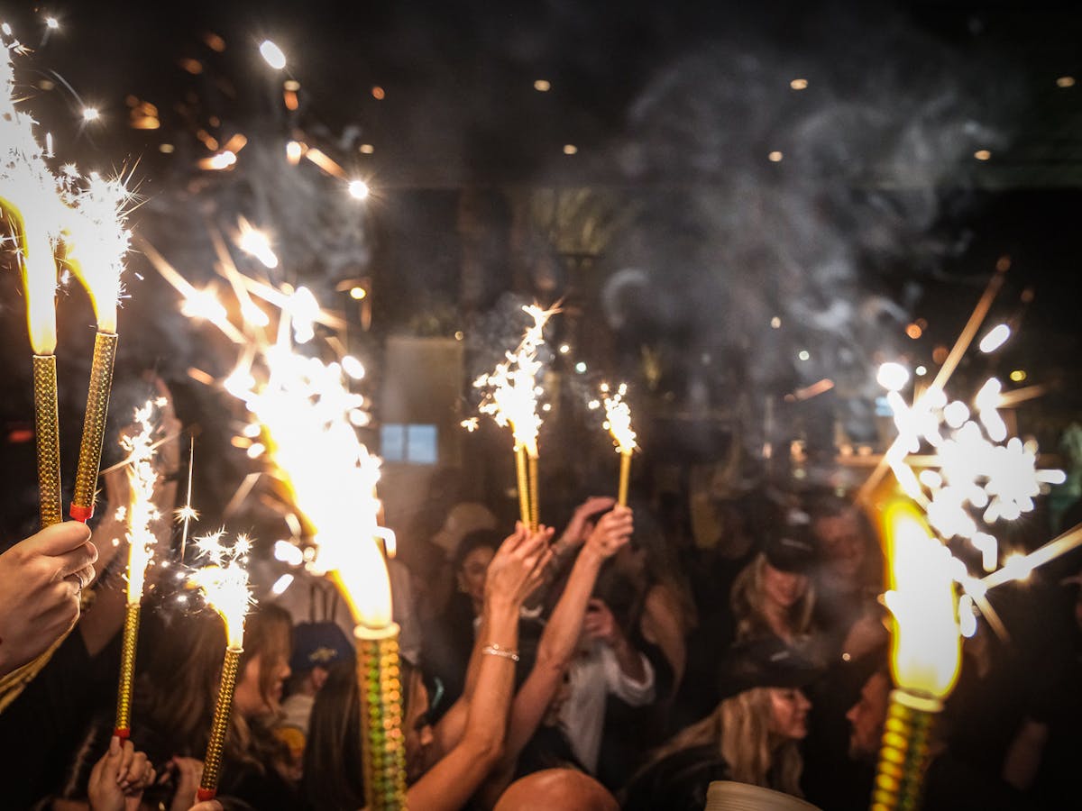 A group of people holding sparklers in the air