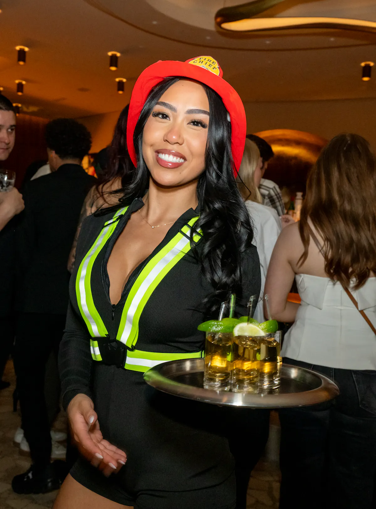 FireHOUSE cocktail server at Bel-Aire Lounge serving drinks during the FireHOUSE event at a Las Vegas lounge with DJ, celebrating local firefighters and first responders.
