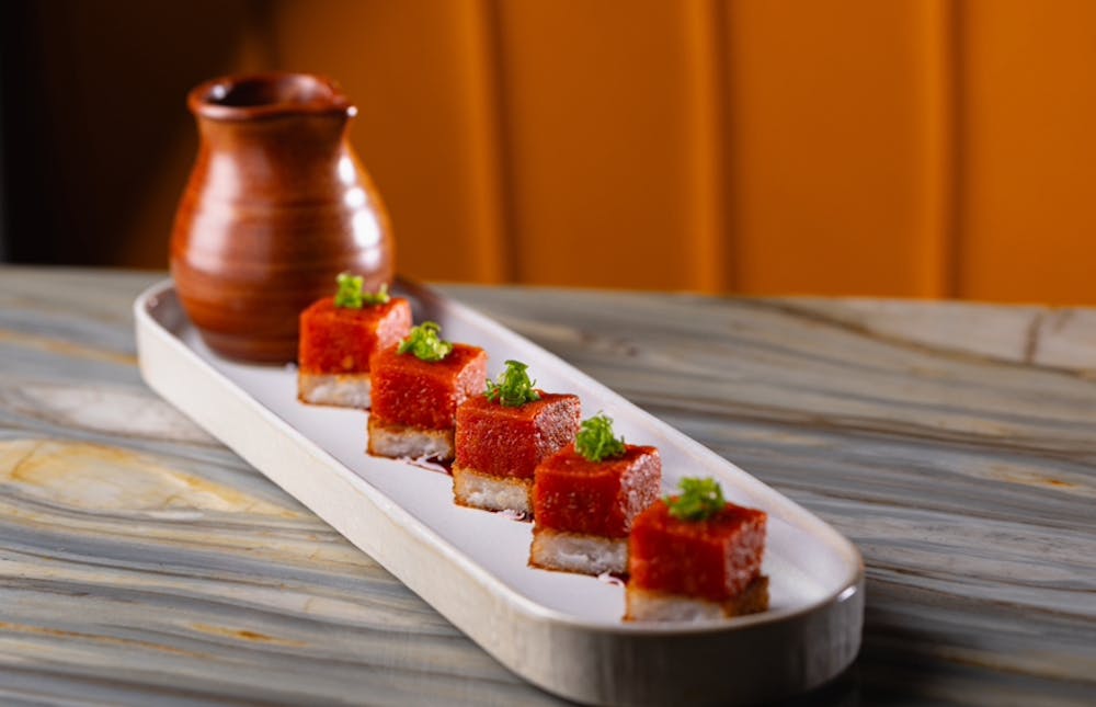 sushi-grade tuna atop a square of fried sushi rice