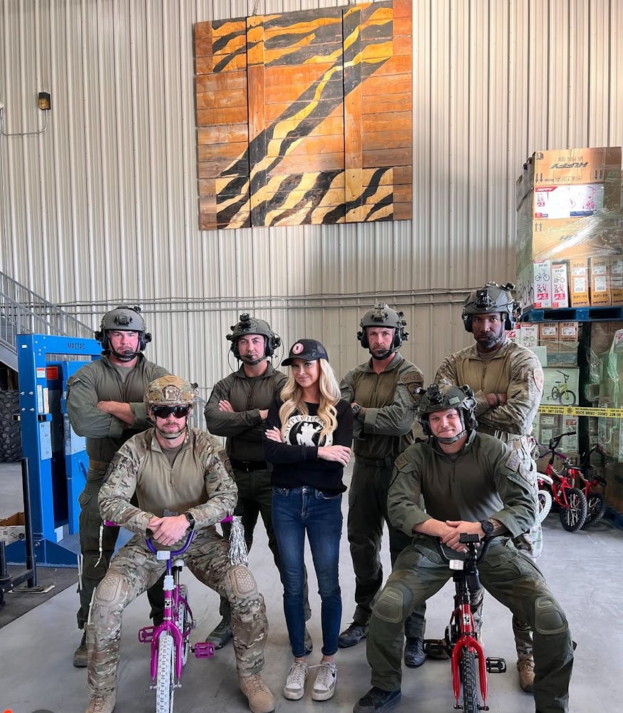 a photo of the Las Vegas swat team and the creator of Superheros4sully bike drive