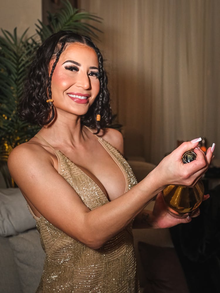 cocktail server at Bel-Aire Lounge opening a bottle of champagne