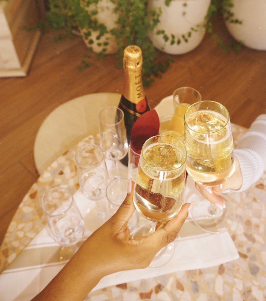 two glasses of champagne with a bottle of Moet in the photo