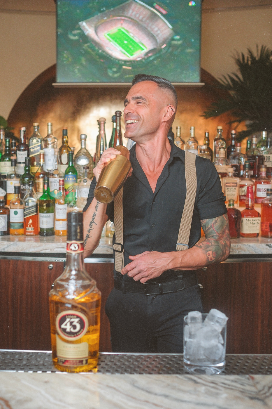 a bartender at Bel-Aire Lounge, a bar near me, shaking a cocktail with liquor 43 