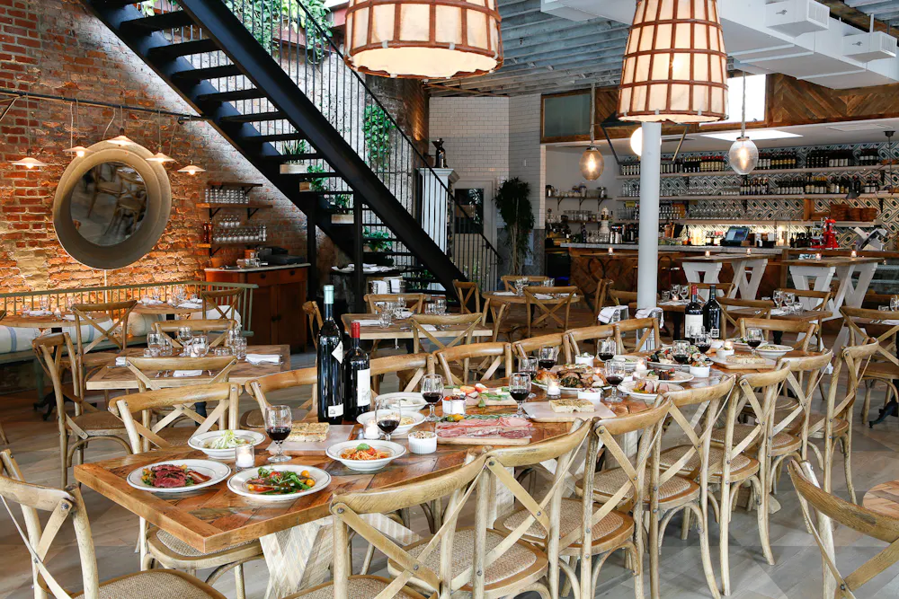 a group of people sitting at a table in front of a building