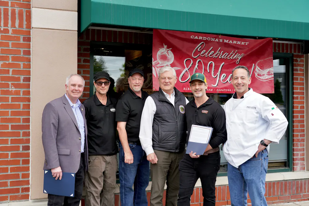 a group of men standing outside a store