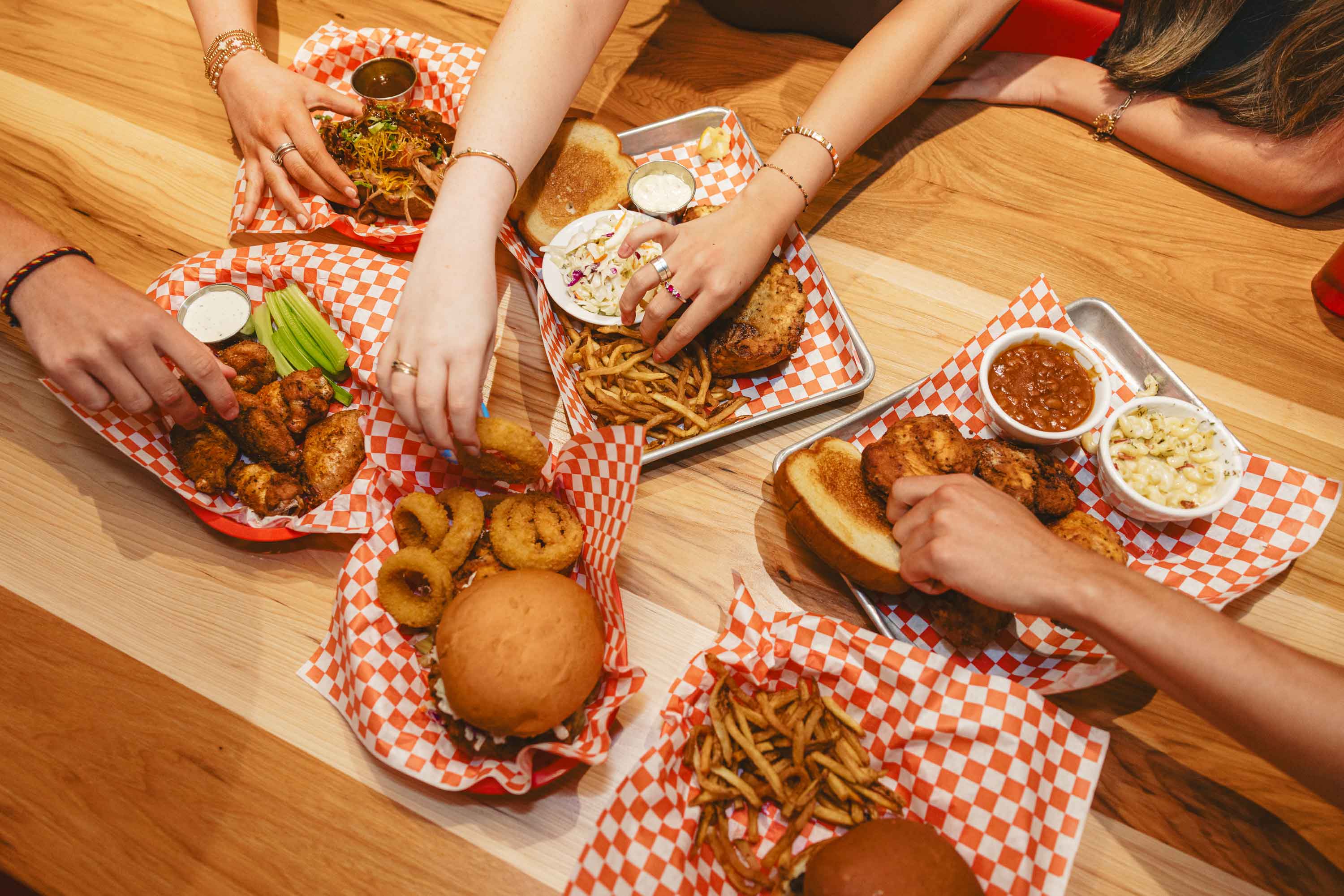 a group of people sitting at a table with food