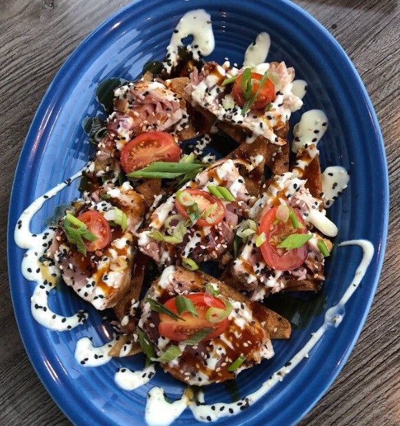 a bowl of salad on a blue plate